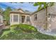 Inviting front entrance with well-kept lawn and manicured landscaping on a sunny day at 29 Woodland Cir, Highlands Ranch, CO 80126