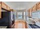 Bright kitchen with wood cabinets, granite countertops, and modern appliances at 29 Woodland Cir, Highlands Ranch, CO 80126