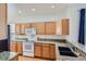 Spacious kitchen featuring oak cabinets, granite countertops, and modern appliances at 29 Woodland Cir, Highlands Ranch, CO 80126