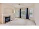 Bright living room with fireplace, large windows with backyard view and a ceiling fan at 29 Woodland Cir, Highlands Ranch, CO 80126