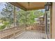 Covered back patio with wood floors and views of the fenced backyard and surrounding trees at 29 Woodland Cir, Highlands Ranch, CO 80126