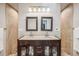 Double sink bathroom vanity with modern fixtures, framed mirrors, stylish tiling, and great lighting at 12690 W 84Th Cir, Arvada, CO 80005