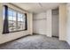 Bright bedroom with large window, plush carpet, and ample closet space at 1240 S Idalia St, Aurora, CO 80017