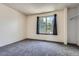 Bright bedroom with neutral carpet and a large window for natural light at 1240 S Idalia St, Aurora, CO 80017