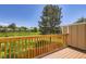 Private wood deck featuring a wood railing overlooking the grass area and lush landscaping at 1240 S Idalia St, Aurora, CO 80017