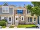 Charming townhome featuring a stone facade, well-maintained lawn, and inviting front entrance at 1240 S Idalia St, Aurora, CO 80017