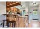 Eat-in kitchen features breakfast bar with stools and wood cabinets at 1240 S Idalia St, Aurora, CO 80017