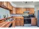 Well-lit kitchen with stainless steel appliances, wooden cabinets, and matching countertop at 1240 S Idalia St, Aurora, CO 80017