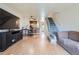 Open-concept living area with wood floors, leading to the kitchen and staircase, offers ample space at 1240 S Idalia St, Aurora, CO 80017