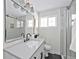 Bright bathroom featuring a glass shower, modern lighting, quartz countertop, stylish sink, and contemporary fixtures at 1360 Wolff St, Denver, CO 80204