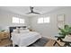 Cozy bedroom with a comfortable bed, two windows providing natural light, and hardwood floors at 1360 Wolff St, Denver, CO 80204