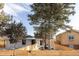 Charming home with a modern exterior, a well-manicured lawn, and mature trees for shade at 1360 Wolff St, Denver, CO 80204