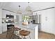Modern kitchen with stainless steel appliances, light countertops, and a stylish island with stool seating at 1360 Wolff St, Denver, CO 80204
