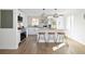 Modern kitchen with stainless steel appliances, light countertops, and a stylish island with stool seating at 1360 Wolff St, Denver, CO 80204