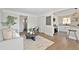 Bright living room featuring hardwood floors, a modern sofa, stylish decor, and an abundance of natural light at 1360 Wolff St, Denver, CO 80204