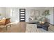 Bright living room featuring hardwood floors, a modern sofa, stylish decor, and an abundance of natural light at 1360 Wolff St, Denver, CO 80204