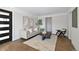 Bright living room featuring neutral decor, hardwood floors, a modern rug, and stylish furniture at 1360 Wolff St, Denver, CO 80204