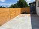 Spacious backyard featuring concrete and a wooden fence and air conditioners at 6500 W 32Nd Ave, Wheat Ridge, CO 80033