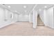 Spacious basement features neutral carpet and a staircase leading to the upper level at 6500 W 32Nd Ave, Wheat Ridge, CO 80033
