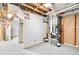 Unfinished basement area showing utility equipment and exposed ceiling at 6500 W 32Nd Ave, Wheat Ridge, CO 80033