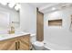 Modern bathroom featuring stylish vanity, marble countertop, and a glass-enclosed shower at 6500 W 32Nd Ave, Wheat Ridge, CO 80033