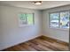 Bright bedroom featuring two windows, wood floors, and neutral walls at 6500 W 32Nd Ave, Wheat Ridge, CO 80033