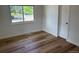 Bedroom with wood floors, closet, and a window bringing in natural light at 6500 W 32Nd Ave, Wheat Ridge, CO 80033