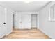 Bright bedroom featuring hardwood floors, a closet, and a window with natural light at 6500 W 32Nd Ave, Wheat Ridge, CO 80033
