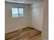 Bedroom with wood floors, closet, and a window bringing in natural light at 6500 W 32Nd Ave, Wheat Ridge, CO 80033