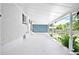 Spacious covered patio with white brick walls and ample natural light at 6500 W 32Nd Ave, Wheat Ridge, CO 80033