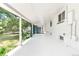 A covered patio featuring a white painted brick wall, white concrete and a lush garden view at 6500 W 32Nd Ave, Wheat Ridge, CO 80033