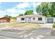 Beautifully renovated white exterior with well-manicured lawn and modern blue accents on doors and trim at 6500 W 32Nd Ave, Wheat Ridge, CO 80033