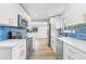 Beautiful kitchen with white cabinets, stainless steel appliances, and open layout at 6500 W 32Nd Ave, Wheat Ridge, CO 80033