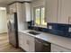 Modern kitchen featuring stainless steel appliances and white cabinetry and tile backsplash at 6500 W 32Nd Ave, Wheat Ridge, CO 80033