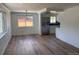 Open-concept living room featuring wood floors, bright windows, and a view into the kitchen at 6500 W 32Nd Ave, Wheat Ridge, CO 80033