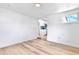 Bright living room with hardwood floors leading to a modern kitchen at 6500 W 32Nd Ave, Wheat Ridge, CO 80033