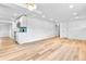 Open floor plan with hardwood floors connecting the living space and kitchen at 6500 W 32Nd Ave, Wheat Ridge, CO 80033