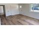 Bright living room features wood floors, white walls, and a large window for natural light at 6500 W 32Nd Ave, Wheat Ridge, CO 80033