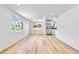 Spacious living room with beautiful hardwood floors, large windows and stainless steel refrigerator at 6500 W 32Nd Ave, Wheat Ridge, CO 80033