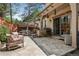 Inviting back patio featuring stone flooring, comfortable seating, and an outdoor kitchen area at 2891 E Alameda Ave, Denver, CO 80209