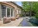 Stone patio with outdoor seating area, lush landscaping, and a dining table at 2891 E Alameda Ave, Denver, CO 80209