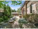 Landscaped backyard featuring a stone walkway, firepit, and a dining table at 2891 E Alameda Ave, Denver, CO 80209