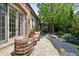Stone patio with an outdoor seating area, lush landscaping, and a stone path at 2891 E Alameda Ave, Denver, CO 80209