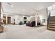 Spacious basement with neutral carpet, media center, fireplace, exercise equipment and staircase at 2891 E Alameda Ave, Denver, CO 80209