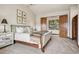 Cozy bedroom with soft carpet, a decorative side table, and a door leading to the outside at 2891 E Alameda Ave, Denver, CO 80209