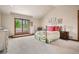 Comfortable bedroom with carpet flooring, side tables, and a door leading to the outside patio at 2891 E Alameda Ave, Denver, CO 80209