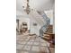 Elegant foyer with staircase, chandelier and view of the fireplace in the living room at 2891 E Alameda Ave, Denver, CO 80209