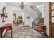 Grand foyer with beautiful tile flooring, chandelier and wrought iron staircase at 2891 E Alameda Ave, Denver, CO 80209