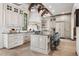 Bright kitchen boasts custom cabinets, large island with seating, and high-end appliances at 2891 E Alameda Ave, Denver, CO 80209