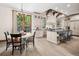 Bright kitchen has custom cabinets and a large island with seating, with an adjacent dining area at 2891 E Alameda Ave, Denver, CO 80209